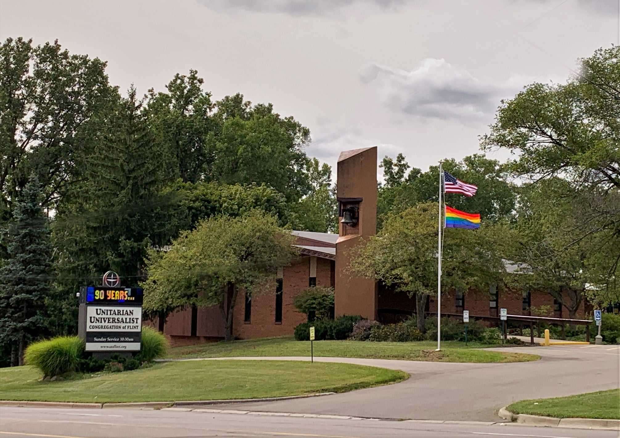 Unitarian Universalist Congregation of Flint building with a rainbow flag